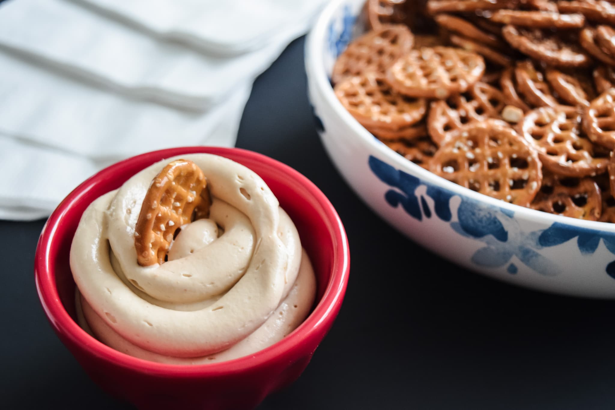 Peanut butter dip made with cream cheese in a small red ramekin