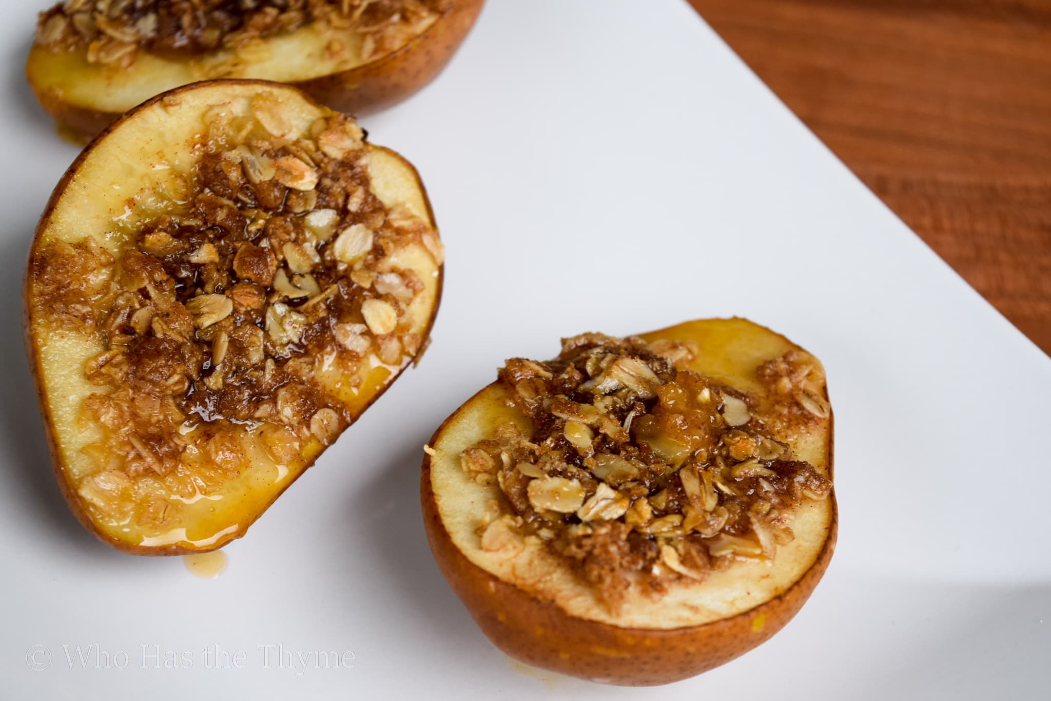 Baked Stuffed Bartlett Pears with Oats Brown Sugar Cut on White Plate