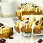 Mini Gluten Free Cranberry Orange Loaves with Vanilla Drizzle on Cooling Rack