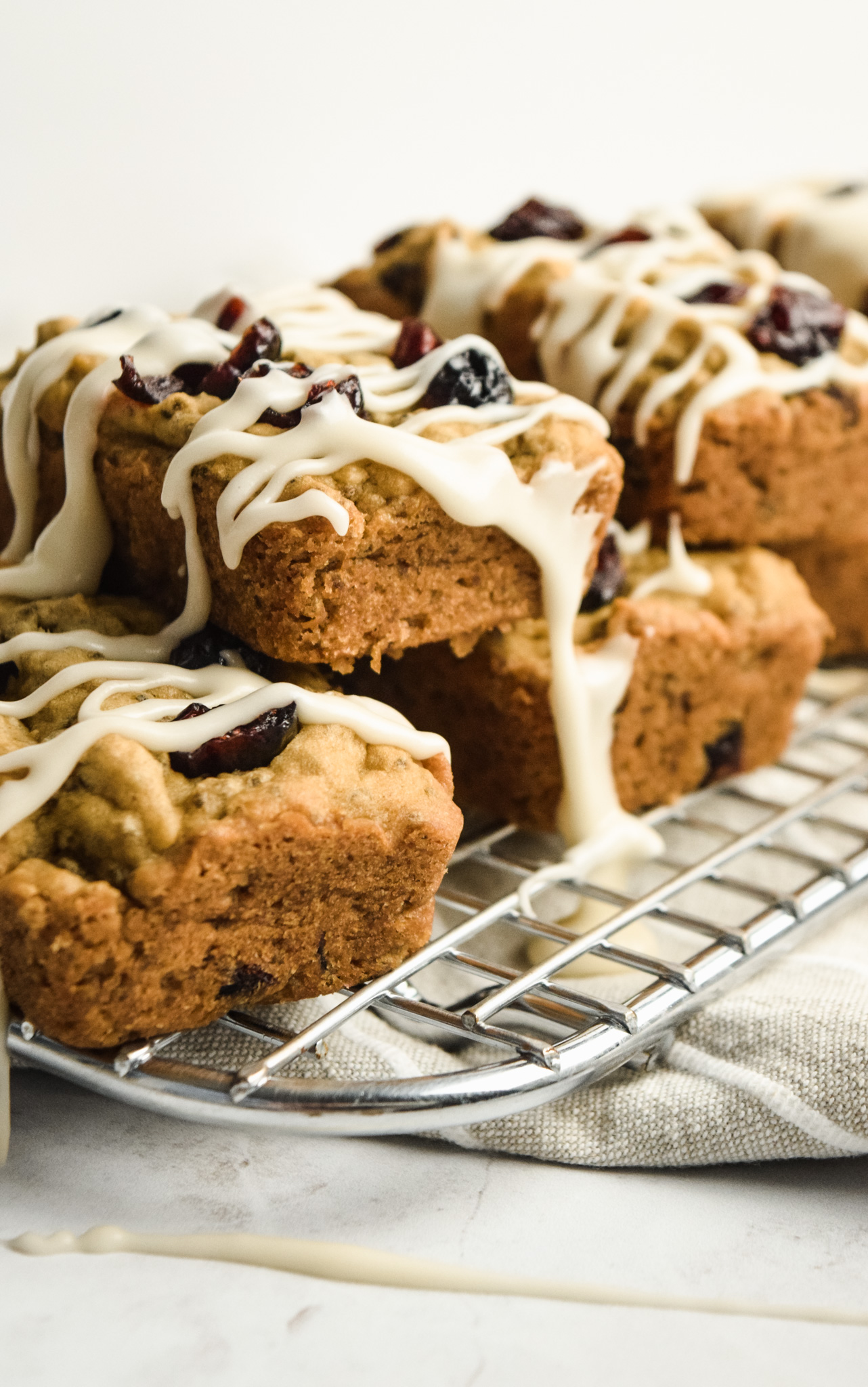 Mini Gluten Free Cranberry Orange Pound Cakes with Vanilla Drizzle on Cooling Rack