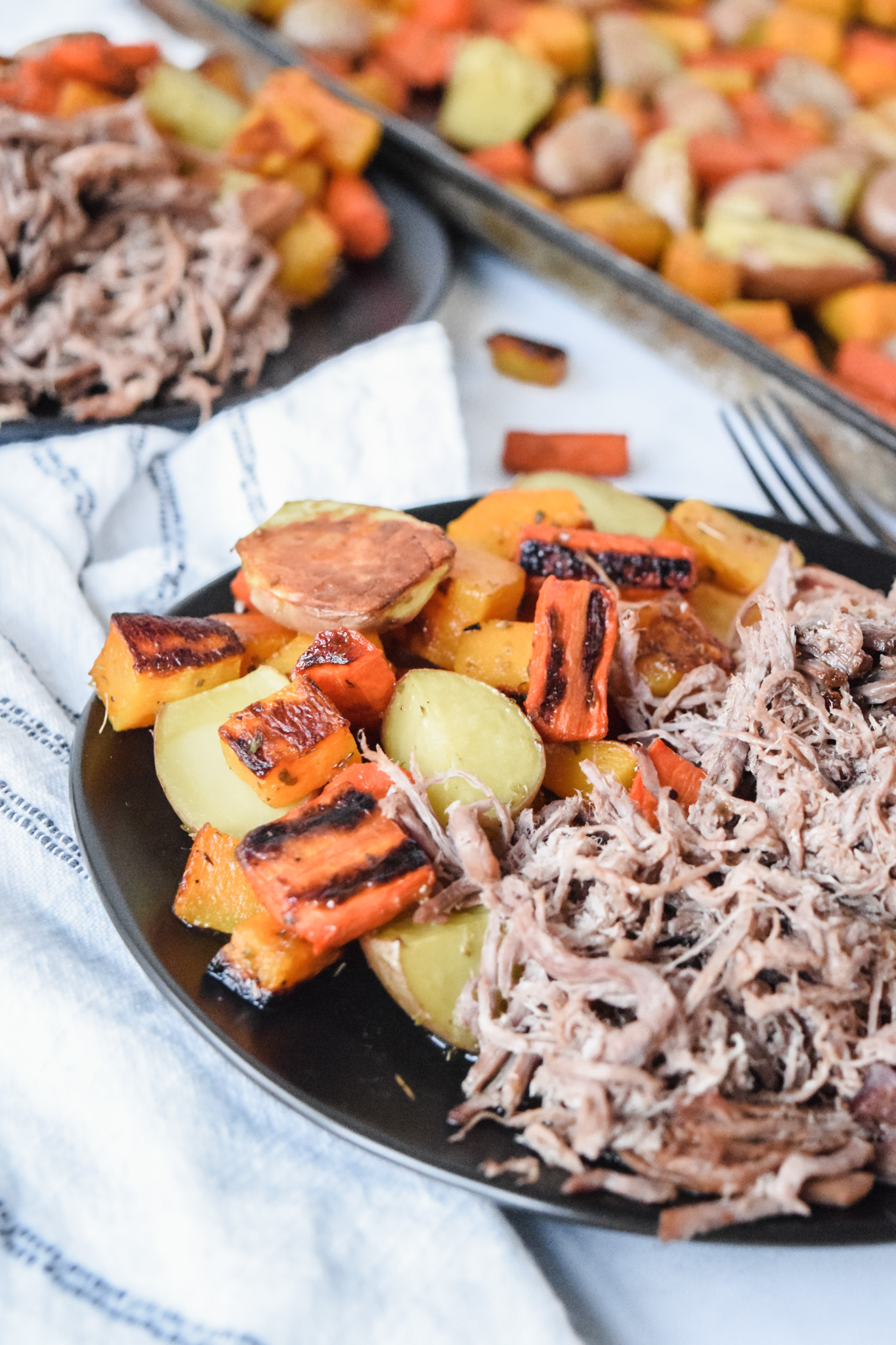 Instant Pot Roast Beef with Roasted Vegetables on a Black Plate