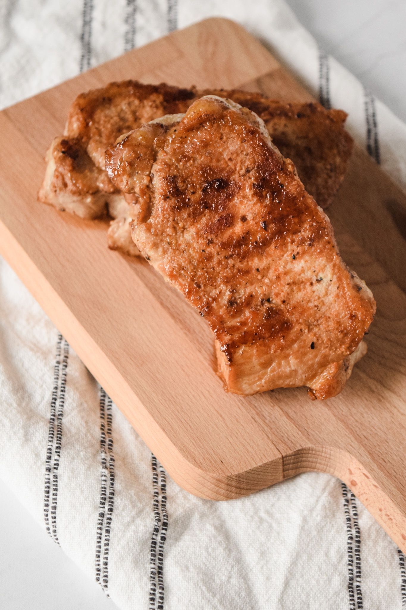 Pan Roasted Pork Chops on a Cutting Board