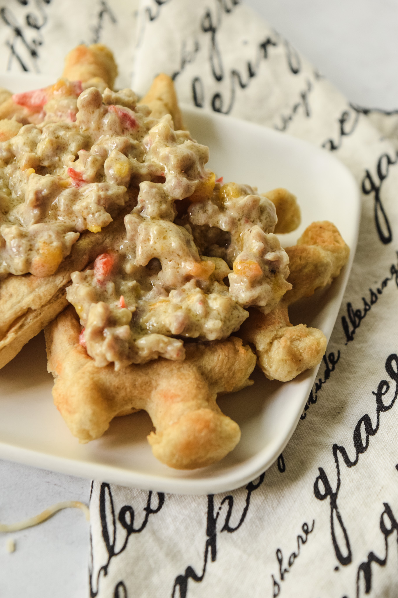 sausage gravy served on top of gluten free cheddar waffles