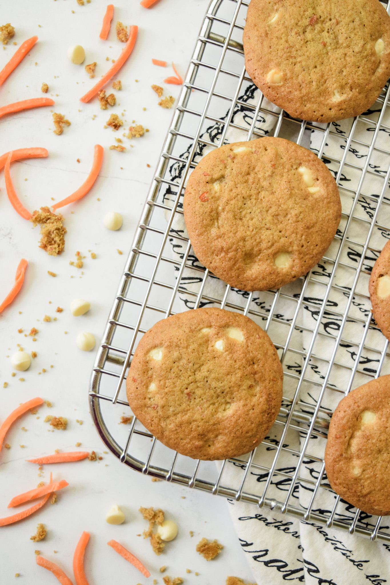 Gluten Free Carrot Cake Cookies with White Chocolate Chips on a Cooling Rack