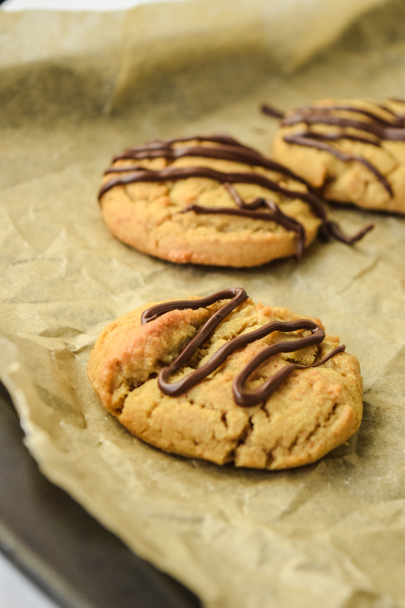Gluten Free Peanut Butter Cookies on a Baking Sheet with Parchment Paper