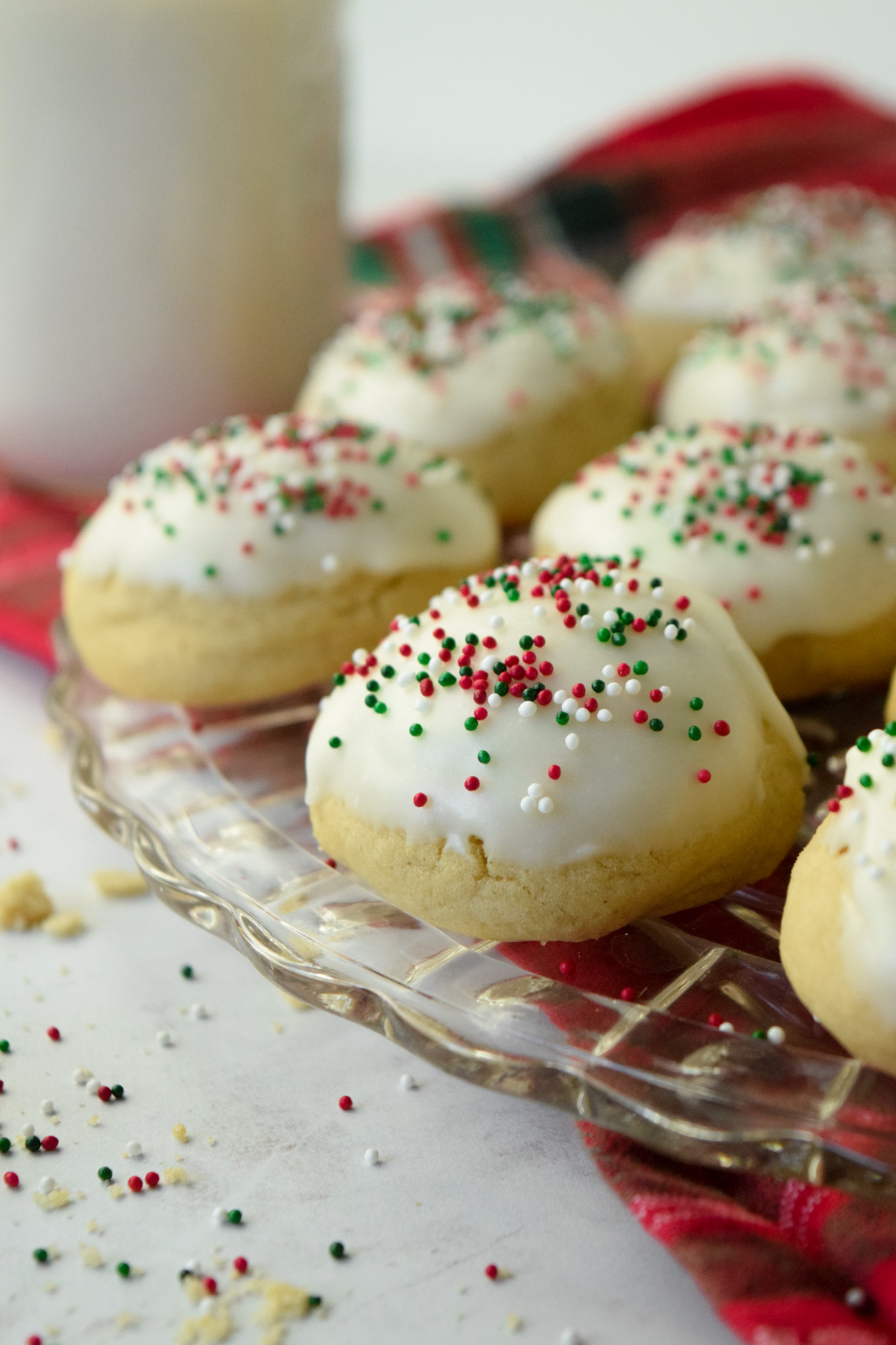 plate of gluten free italian christmas cookies with almond extract and a vanilla glaze