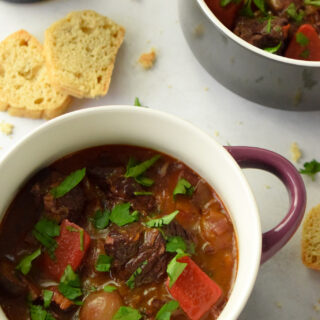 French beef stew with red wine in a crock