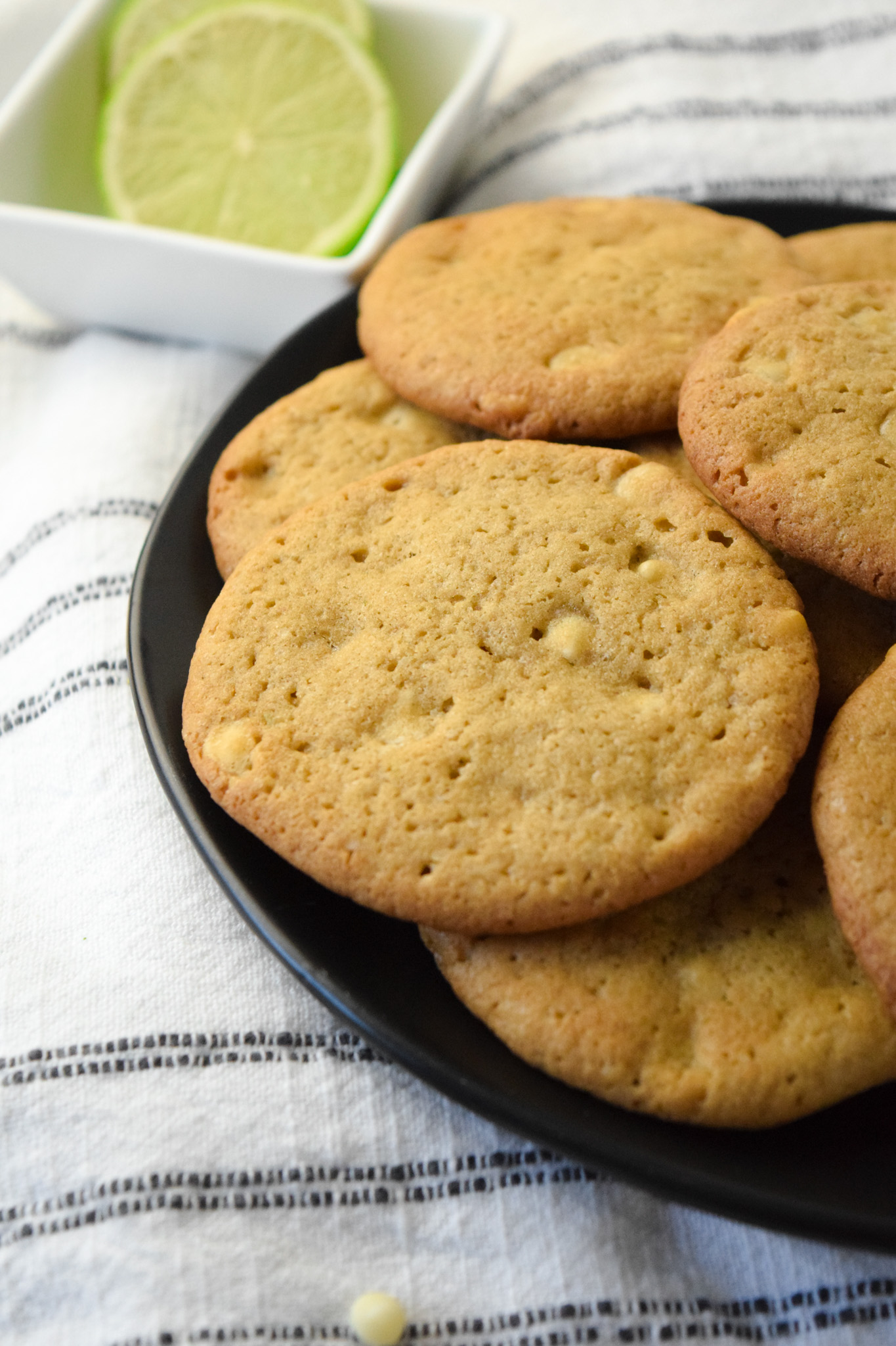 black plate of gluten free key lime cookies with mini white chocolate chips
