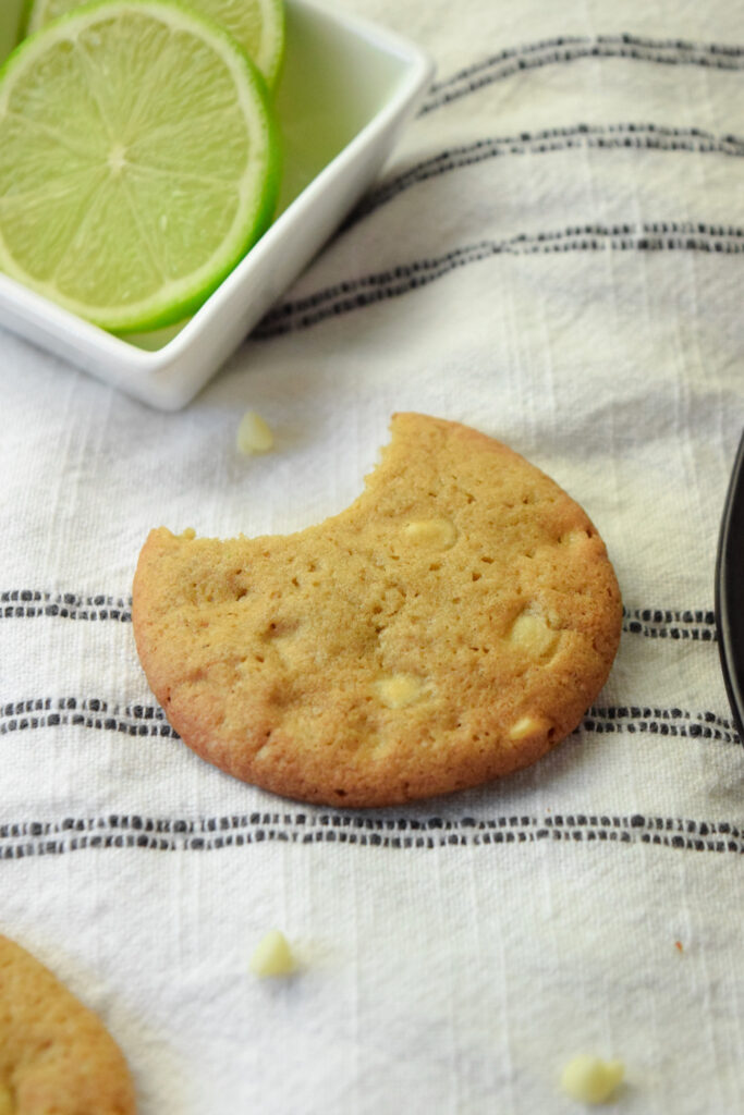 gluten free key lime cookie with white chocolate chips and a bite missing